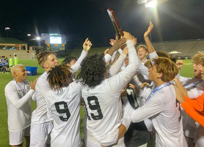 The East Ridge boys loft their prize for capturing the FHSAA 7A state championship.